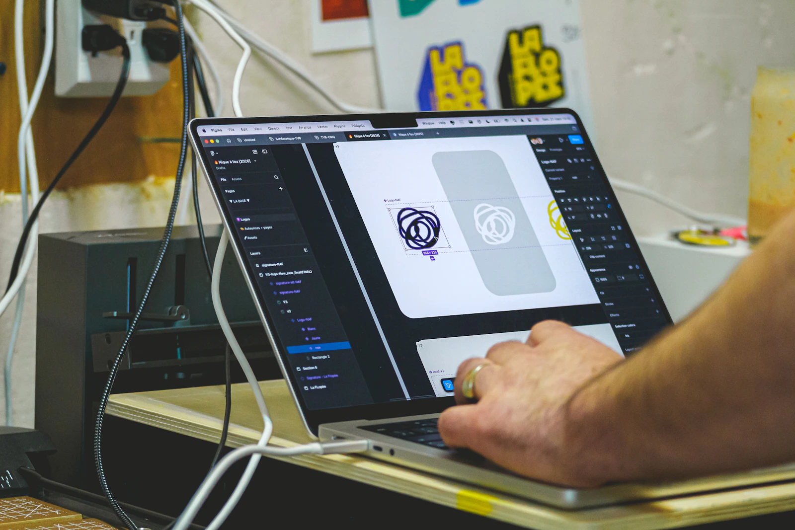 Person creating a visual design on a laptop