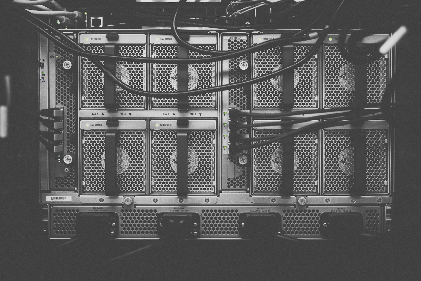 Black-and-white close-up of server hardware, cabling and cooling fans